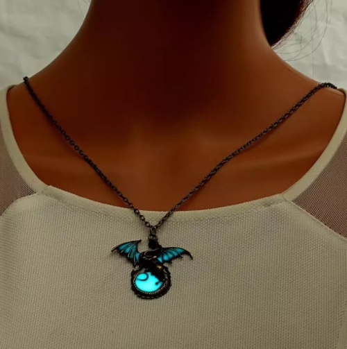 Girl wearing a glowing dragon pendant